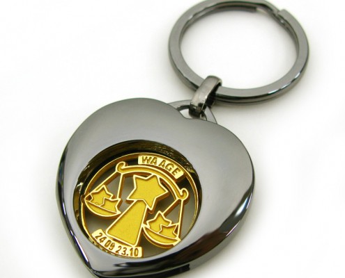 Heart Shape Metal Coin Keyring with cute logo in its hollow.